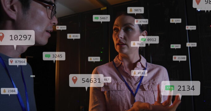 Image of notification bars over diverse coworkers discussing on laptop in server room - Powered by Adobe