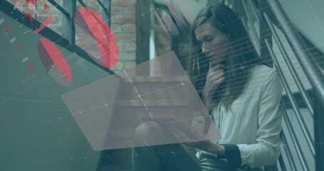 Image of statistical data processing over caucasian woman using tablet on the stairs at office