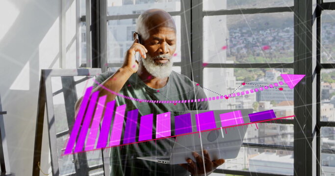 Image of arrow on graph over senior african american man with laptop talking on smartphone
