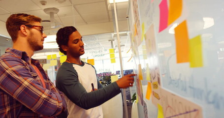 Image of data processing and diagrams over diverse business people discussing work