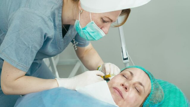 The introduction of plasma under the skin is an innovative method of lifting and tightening the face. This cosmetology procedure gives the client youth and beauty of the skin. High quality 4k footage