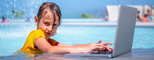 Conceptual image of distance learning. Young beautiful happy girl learning with laptop computer in the swimming pool. Selective focus.