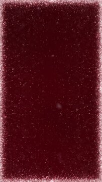 Vertical Snow Glitter Frame on Red 4K Loop features a white particle frame with particles being drawn to the far distance in a dark red atmosphere in a vertical ratio loop. 