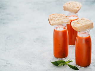Gaspacho soup in glass bottles, copy space