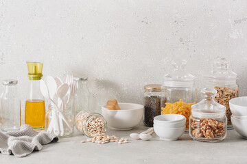 eco friendly kitchen storage. glass jars of grains , pasta and nuts, transparent containers for pantry.