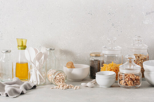 eco friendly kitchen storage. glass jars of grains , pasta and nuts, transparent containers for pantry.