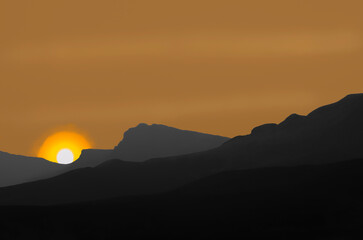 Colorized Digital Art Image of Sunset over Layered Hills