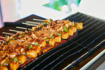Grilling chicken meat on barbecue grill