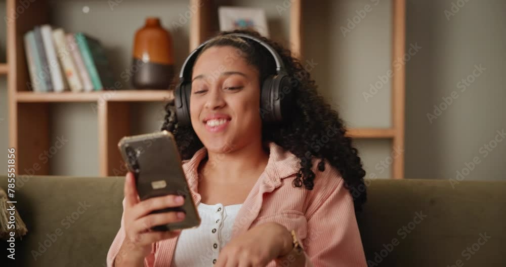 Sticker Girl, couch and dance on smartphone with headphone for music playlist and smile for entertainment. Female person, lounge and sofa on internet for streaming platform with song or album at home