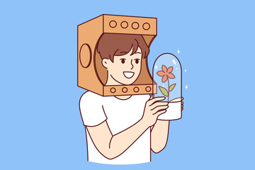 Child in paper astronaut helmet dreams of flying into space on shuttle, holding flask with plant in hands. Boy astronaut fantasizing about research mission to other planets to grow flowers - 785552211