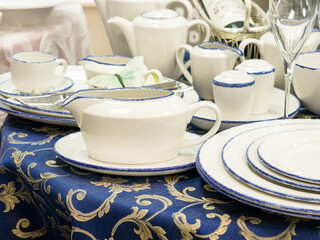 Set of new disheson table with blue tablecloth