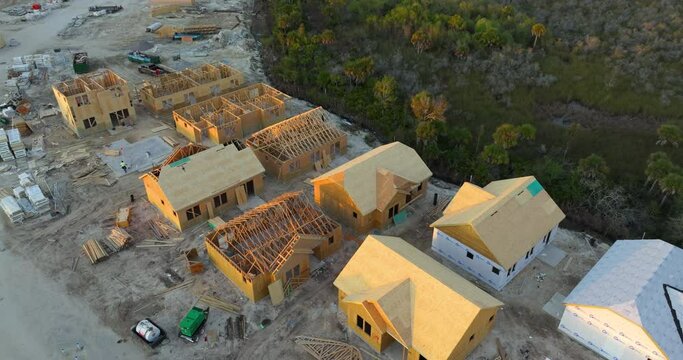 Wooden houses under construction in new developing suburban area. Development of residential housing in American suburbs. Real estate market in the USA.