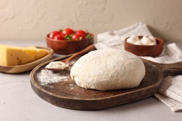 Pizza dough and products on gray table