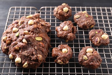 Raw chocolate dough with nuts on black table