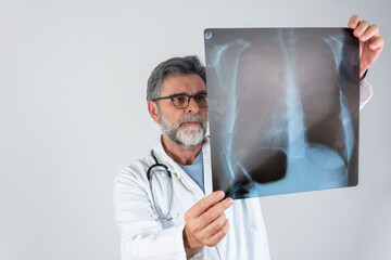 Doctor examining chest x-ray film of patient at hospital. Lung radiography concept. radiology doctor examining at chest x ray film of patient at hospital room. Male doctor looking at the x-ray picture - obrazy, fototapety, plakaty