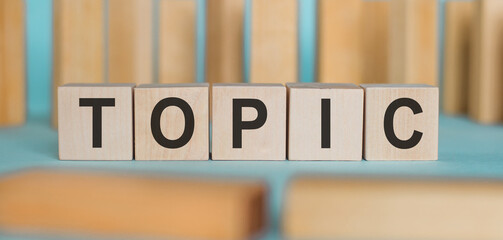 Wooden Blocks Spelling the Word Topic on a Table