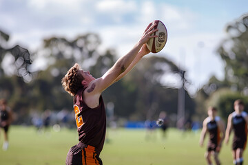an australian rules football player catching the ball