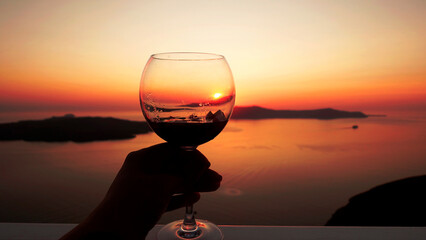 silhouette of a glass of wine at sunset - obrazy, fototapety, plakaty