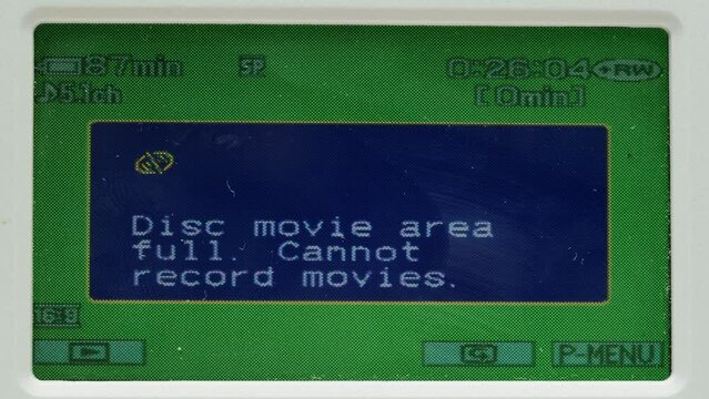 Old vintage video camera close-up. Popular retro camcorder shooting. Chroma key green screen on video-camera monitor.