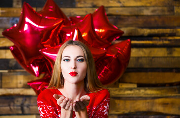 Happy woman with holding red balloons