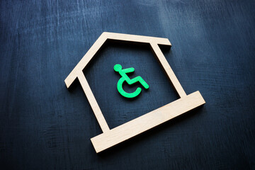 Disabled Person sign and house as symbol of real estate. Accessible home ownership rights.
