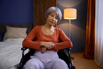 Aged senior woman in wheelchair at home or retirement house - obrazy, fototapety, plakaty