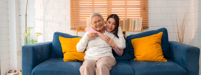 Asian Family Bonds: Daughter's Laughter Echoes in the Home as Grandfather and Grandmother Enjoy...