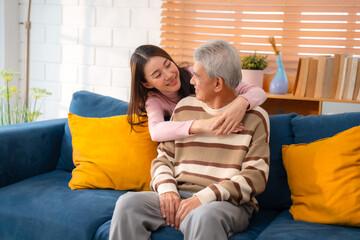 Generational Bonding: Cheerful Young Woman Embraces Elderly Parents at Cozy Home, Radiating...
