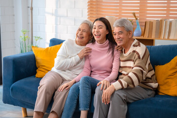 Generational Bonding: Cheerful Young Woman Embraces Elderly Parents at Cozy Home, Radiating Happiness and Family Love