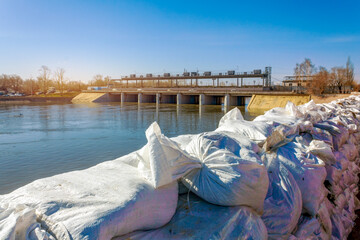 The water dam, accompanied by flood prevention sandbags on the embankment of the Tobol River, located in Kurgan, Russia.