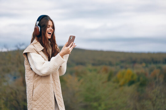 Mountain Melodies: A Free-Spirited Woman Dancing in Nature with Headphones