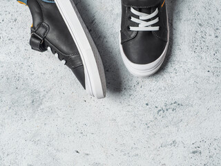 Gray and yellow sneakers on gray background