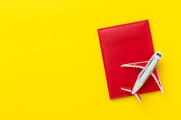 Red passport with airplane on color background, top view