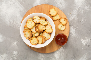 Spiced bruschette chips on concrete background, top view