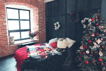 Cozy bed with cups of coffee and wrapped gift box