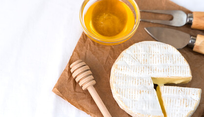 Cheese Camembert and honey on the table for breakfast. Close-up. Top view. Copy space.