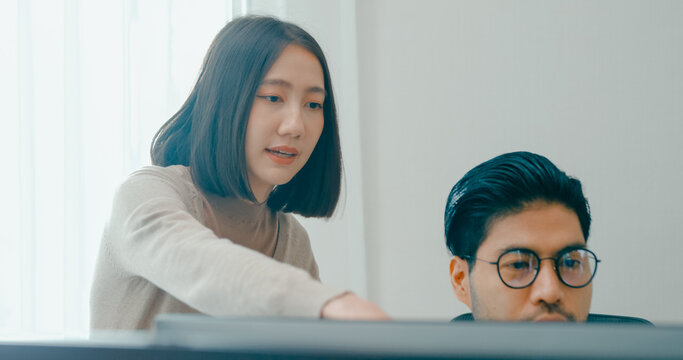Group Adult Asia male, female freelance meeting write prompt AI bot IT app smart program nomad, video game, talk strategy, discuss plan, user interface, designer, big data center on desktop computer.