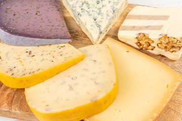 Various types of exclusive cheeses on wooden table. Top view.