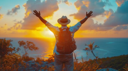 Man in Hat Standing on Cliff Overlooking Ocean