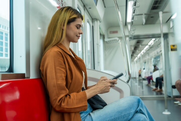 Woman Using Smartphone on Subway Train