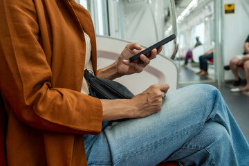 Woman Using Smartphone on Subway Train