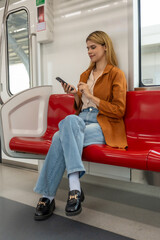 Woman Using Smartphone on Subway Train