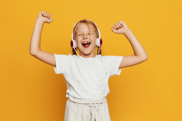 Young girl celebrating with arms raised