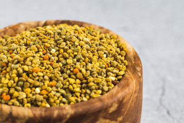 Bee pollen or perga textured background . Raw brown, yellow, orange and blue flower pollen grains or bee bread texture pattern. Healthy food supplement