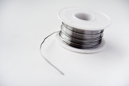 Tin-lead solder in coils on a white background. Materials for soldering.