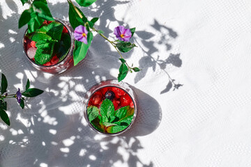 Berry refreshing cold summer drink. Cocktail or mocktail with ripe seasonal berries and mint. Detox...