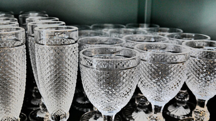 Close-up of many crystal wineglasses on a shelf