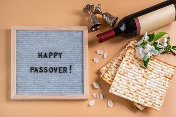 Happy Passover. Bottle of wine, spring flowers and matzah bread