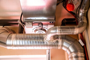 Ventilation pipes in building. Heating and cooling distribution ducts.
