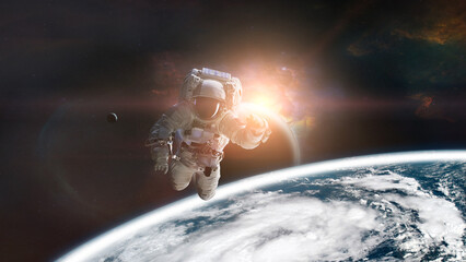 Astronaut in outer space on low-orbit of Earth planet with sunlight. Elements of this image...